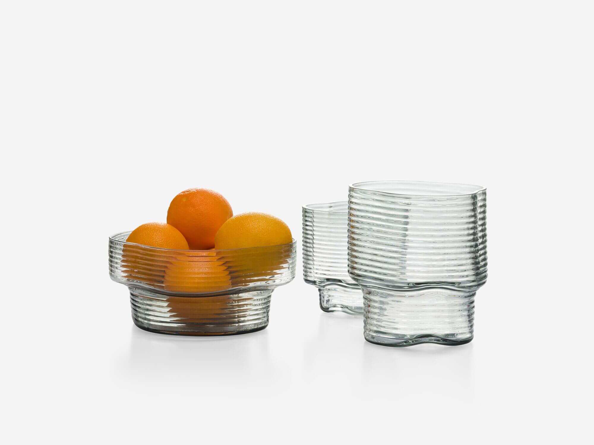 Group of two wavy glass vases and bowl with oranges